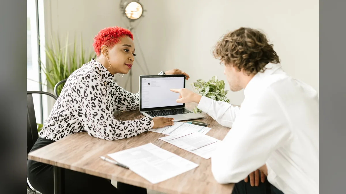 Marketing and compliance team members reviewing content together before publication
